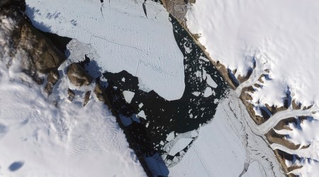 This Aug. 16, 2010, image provided by NASA Earth Observatory shows a piece of the Petermann Glacier that cracked in Greenland. (Jesse Allen and Robert Simmon/NASA Earth Observatory via AP)