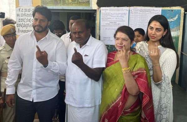 JD(S) leader HD Kumaraswamy and his wife Anitha Kumaraswamy, along with their son Nikhil Kumaraswamy and his wife Revathi, pose after casting their votes in Karnataka Assembly elections. (Express photo)