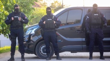Police officers block the street near the scene of a Thursday night attack in the village of Dubona, some 50 km south of Belgrade, Serbia, Friday, May 5, 2023. (AP)