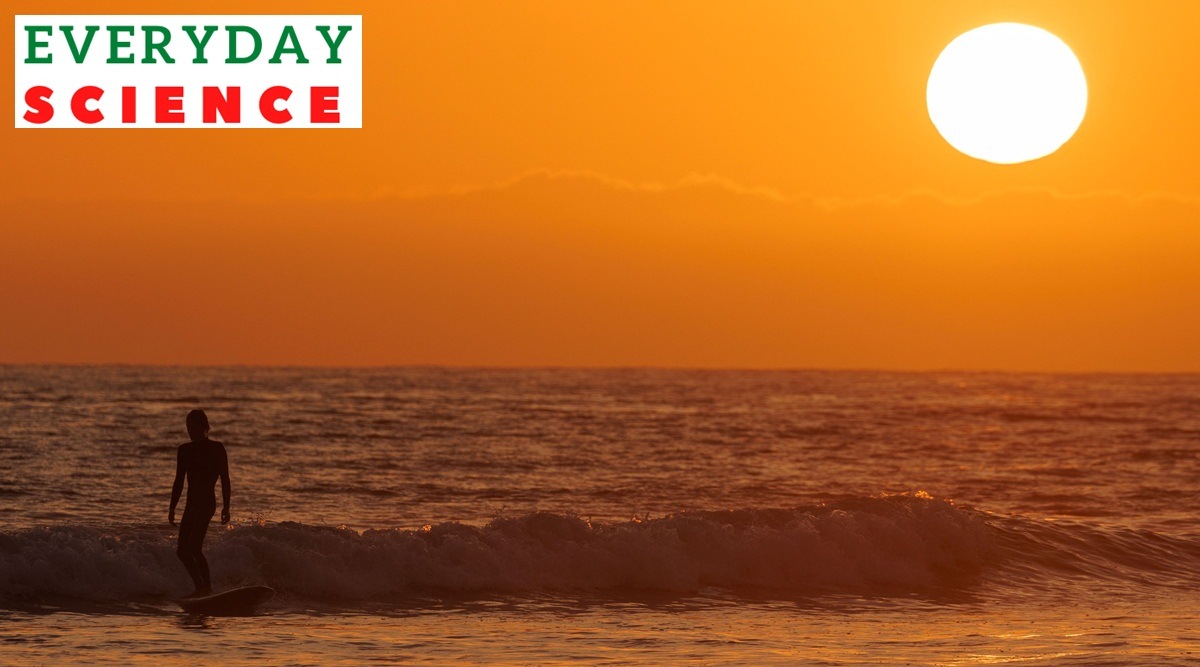 A surfer catches one of the last waves of the day as the sun sets on the summer solstice marking the longest day in the Northern Hemisphere, off Cardiff State Beach in Encinitas, California, U.S., June 21, 2023.