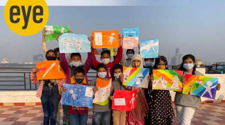 Children holding up the artwork produced during a workshop.