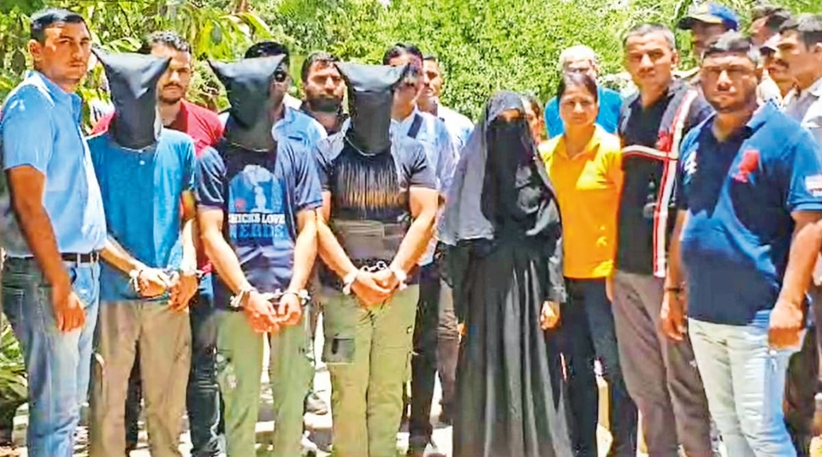 Gujarat ATS with the arrested persons on Saturday. PTI