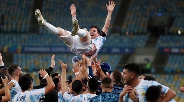 Lionel Messi is thrown into the air by Argentina teammates.