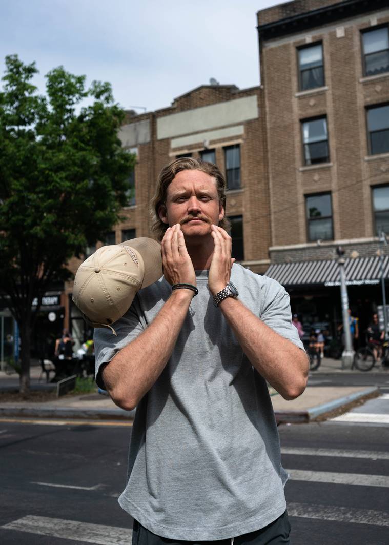 Alex Booher, a business student who sports a mustache, in New York on May 13, 2023. (Ali Cherkis/The New York Times)