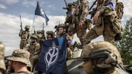 Members of the Free Russia Legion and the Russian Volunteer Corps pose for reporters during a media event in the Sumy region of Ukraine, May 24, 2023.