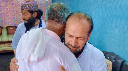 People offer their support to Raja Yousaf, right, whose son Raja Sajid is missing after a shipwreck off the Greek coast, in Bindian village in Kotli, a district of Pakistan-occupied Kashmir, June 18, 2023. (AP)