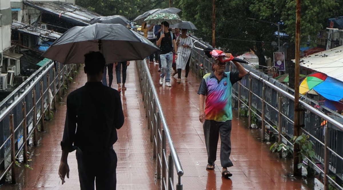 New Delhi, India. 19th July, 2021. Prime Minister Narendra Modi holds an  umbrella to protect from the rain as he addresses the media on the opening  day of the monsoon session of