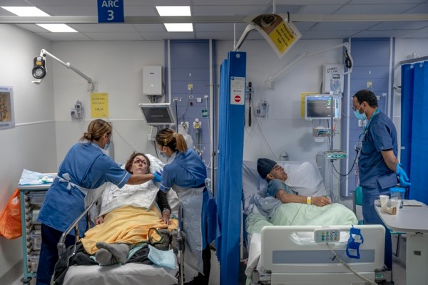 Michelle Scanlan, left, and Kaushik Bhatt in the emergency unit at Queen's Hospital in Romford, England, March 20, 2023. (Andrew Testa/The New York Times)