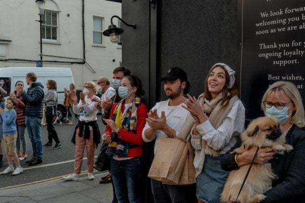 People applaud during a weekly public appreciation of frontline healthcare workers during the COVID-19 pandemic, outside Chelsea and Westminster Hospital in London, April 7, 2020. (Andrew Testa/The New York Times)