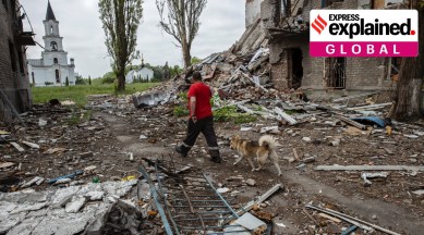 A local walks with his dog through destruction wrought by Russian shelling in Avdiivka, Ukraine on June 12, 2023
