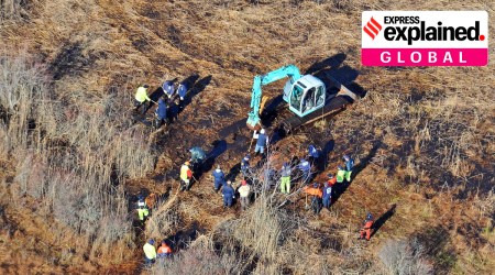 In this Dec. 8, 2011 photo, investigators use a backhoe to dig while searching for Shannan Gilbert's body in different sectors of a marsh area just east of Oak Beach, N.Y.