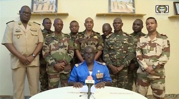 In this image taken from video provided by ORTN, Col. Maj. Amadou Abdramane, front center, makes a statement late Wednesday, July 26, 2023, in Niamey, Niger, as a delegation of military officers appeared on Niger State TV to read out a series of communiques announcing their coup d'etat. 