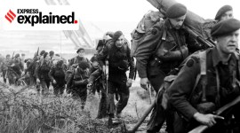 Royal Marine Commandos move inland from Sword Beach on the Normandy coast, 6 June 1944. Royal Marine Commandos attached to 3rd Division for the assault on Sword Beach move inland, 6 June 1944. A Churchill bridgelayer can be seen in the background.
