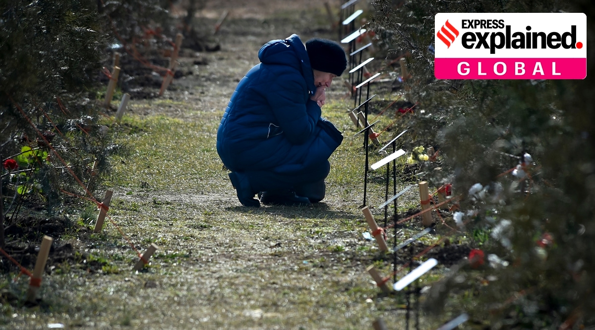 Mother leaning in front of grave