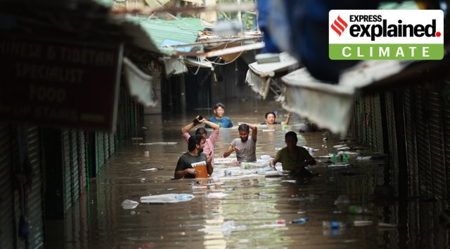 People wade through a submerged Monastery in Budha Vihar Market, after waters in the Yamuna rose to its highest recorded levels in New Delhi on Wednesday.