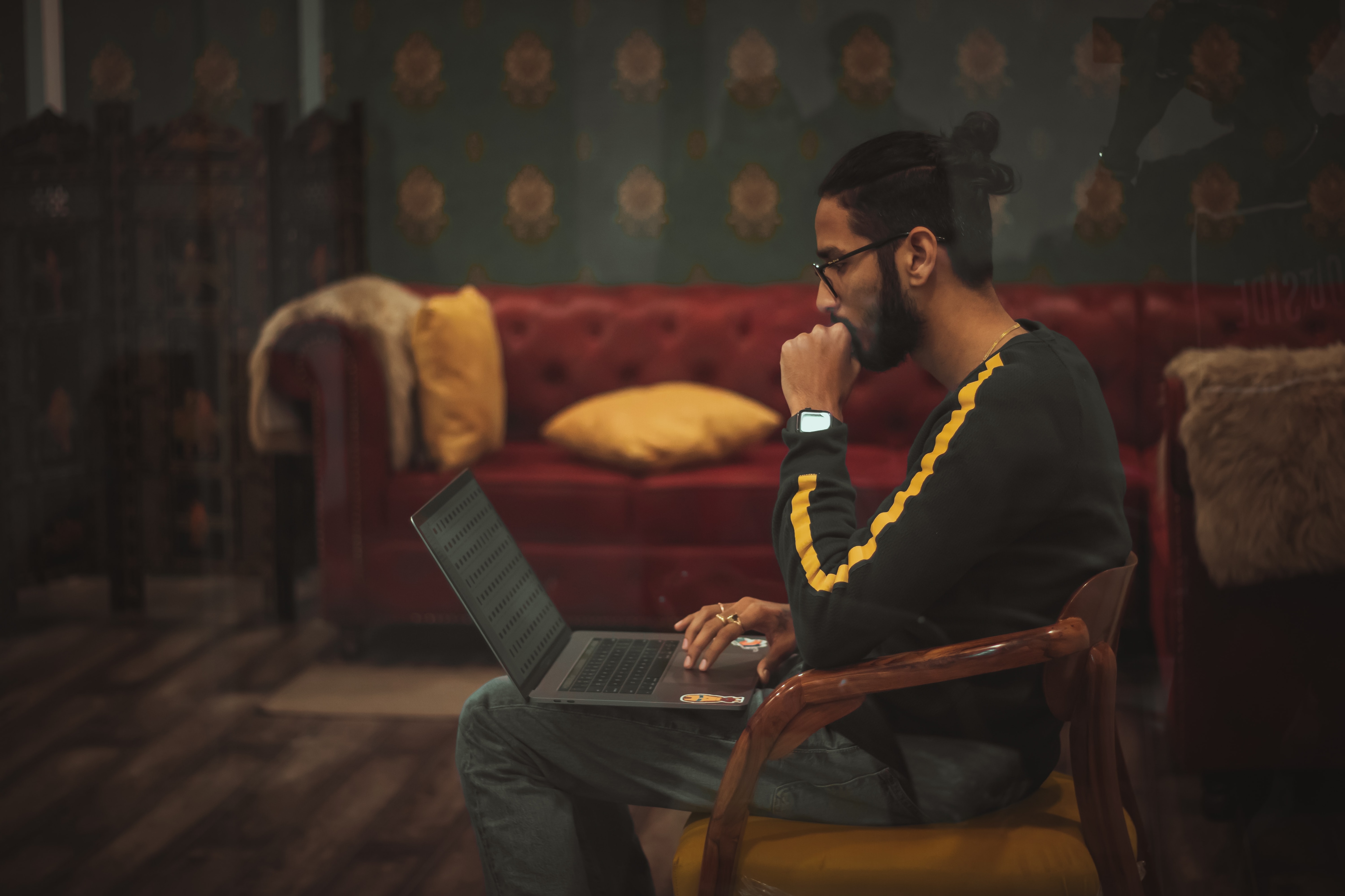 man solving online crossword on computer