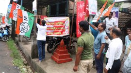 TMC workers put up flags outside a party office at Subsit Gram Panchayat in Bagnan of Howrah district. (Express photo by artha Paul)