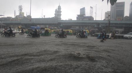 People waded through knee-deep water, while two-wheeler riders faced problems as water entered the vehicle engines. (Express photo by Hanif Malek)