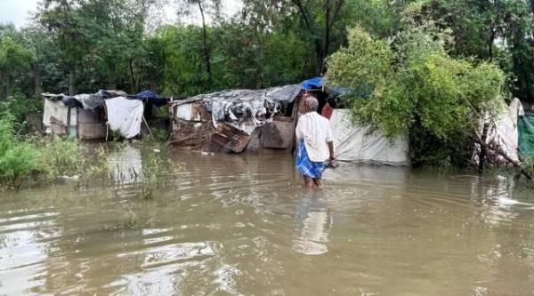 Residents were seen wading through the deep waters of the Yamuna Bank near the old iron bridge.  (Quick photo by Saman Hussain)