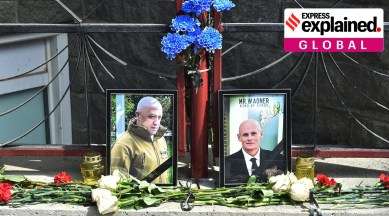 A view shows portraits of Russian mercenary chief Yevgeny Prigozhin (left) and Wagner group commander Dmitry Utkin at a makeshift memorial outside the local office of the Wagner private mercenary group in Novosibirsk, Russia, August 24, 2023.
