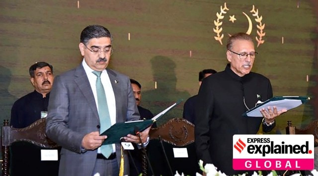 In this photo released by Pakistan's President Office, President Arif Alvi, right, administrates oath from Anwaar-ul-Haq Kakar as caretaker Prime Minister during a ceremony, in Islamabad, Pakistan, Monday, Aug. 14, 2023.