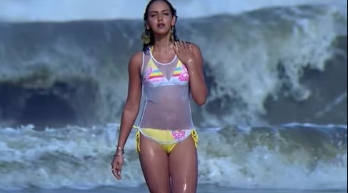 An Indian white beautiful women in a blue thong bikini on a beac 