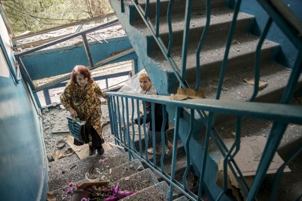 Residents survey damage from two Russian missile strikes in the Ukrainian city of Pokrovsk, about 43 miles to the east of the Russian-occupied city of Donetsk and 30 miles from the front line, on Tuesday, Aug. 8, 2023. At least seven people — including one rescuer — were killed in the Monday evening strikes on Pokrovsk. Officials said 81 people were injured, including 38 emergency workers and two children. (Tyler Hicks/The New York Times)