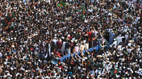 Protesters shout slogans and block an intersection following overnight attacks and vandalism after the death of a prominent activist, who was shot by an assailant a week ago, in Dhaka. (AP)
