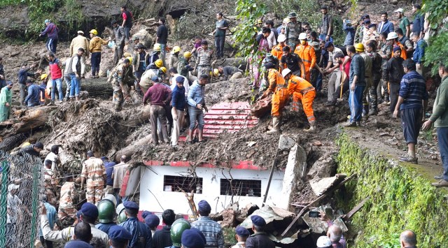 Rescuers remove mud and debris as they search for people feared trapped after a landslide near a temple on the outskirts of Shimla, Himachal Pradesh, Aug.14, 2023. (AP)