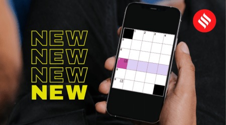 indian playing a mini crossword on phone online