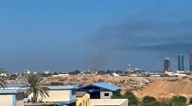 Smoke rises amid clashes between armed factions, in Tripoli