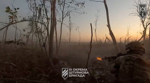 A Ukrainian soldier shoots from his position, amid Russia's attack on Ukraine in a location given as near Bakhmut