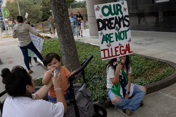 Deferred Action for Childhood Arrivals policy recipients Susana Lujano, 30, provides water to her one year old son Joaquin next to Brendaletzy Lopez, 30, who holds a placard ahead of a hearing on the DACA program outside the federal courthouse in Houston, Texas, U.S., June 1, 2023. 