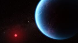 Illustration of a blue coloured planet with a faint red dwarf star in the background
