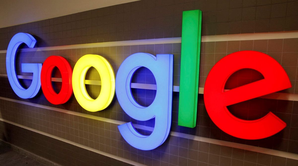 An illuminated Google logo is seen inside an office building in Zurich