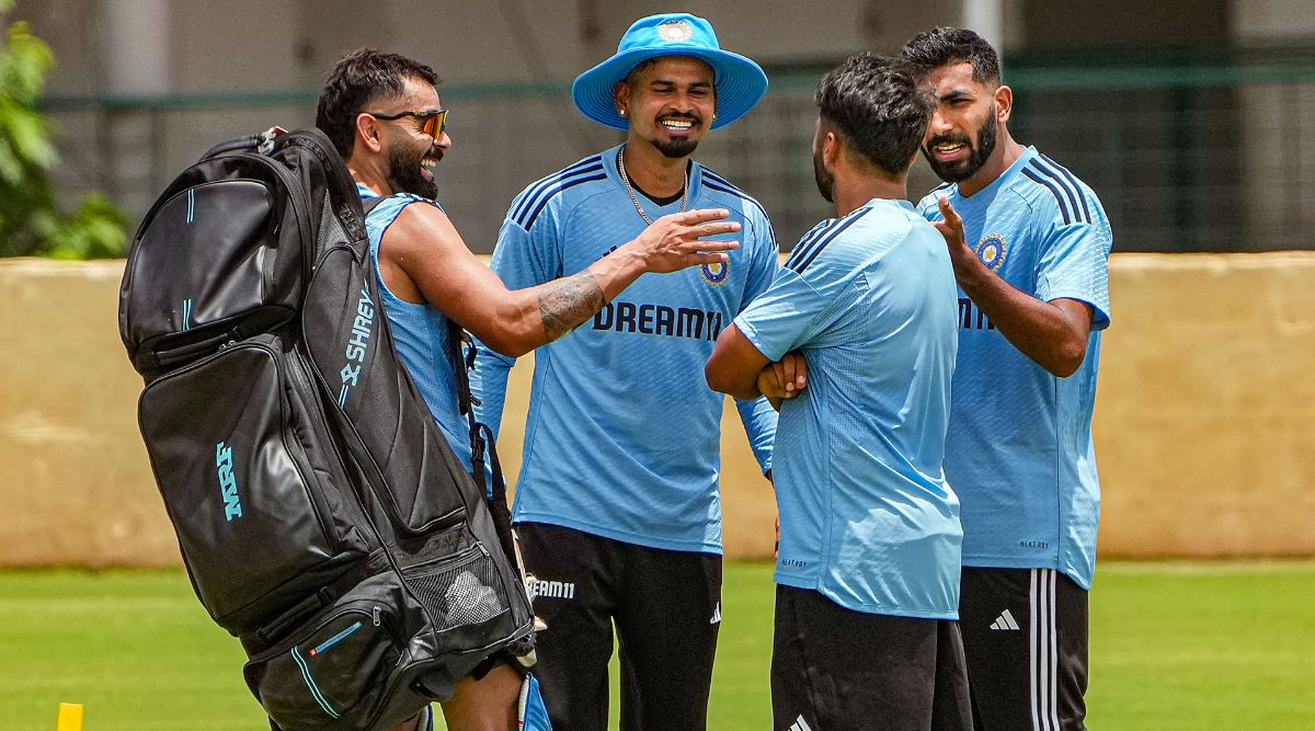 A spectator wears a floppy hat, part of a team give away for those