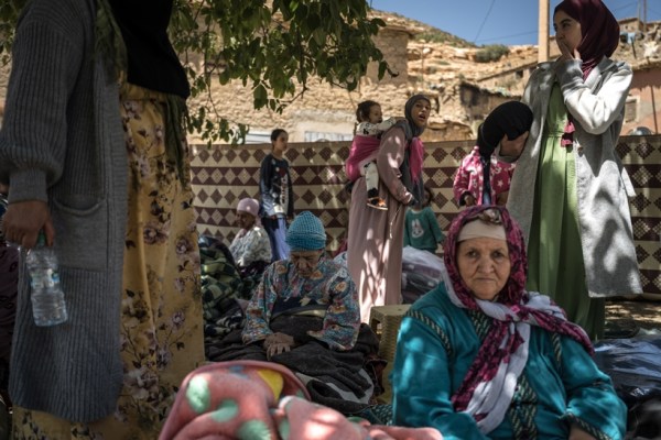 Local women and children at an emergency shelter in the village of Azgour, Morocco, on Sunday, Sept. 10, 2023. Rescuers in Morocco raced to reach remote areas in the mountains outside Marrakech on Sunday after the worst earthquake to hit the area in a century flattened homes across central and southern parts of the country, killing more than 2,000 people. (Sergey Ponomarev/The New York Times)