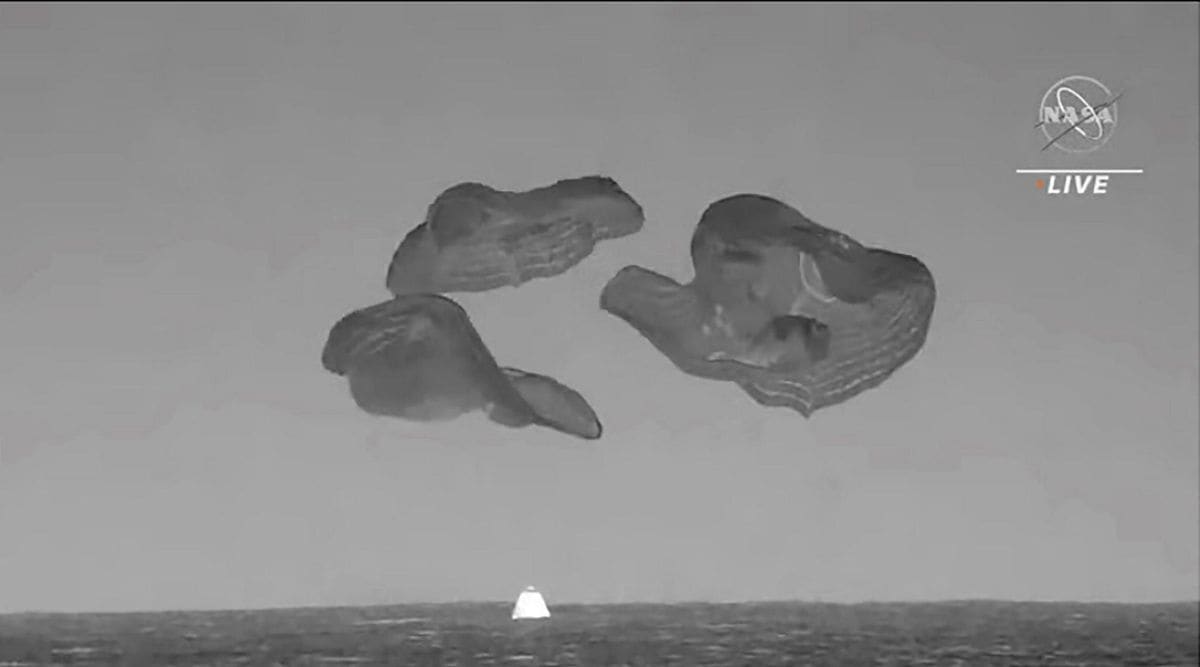 In this image from video made available by NASA, a SpaceX capsule, slowed by parachutes, splashes down in the Atlantic Ocean off the Florida coast, Monday, Sept. 4, 2023