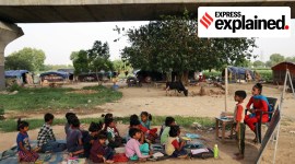 Students from a slum attend a classroom session at the Yamuna riverbed near Mayur Vihar in New Delhi in 2023.