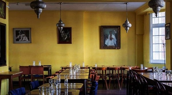 india club in london with portraits showing MK Gandhi and other Indians.