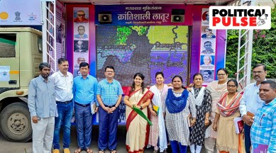 People pose for photographs in front of a 'chitra rath' (chariot) adorned with images and the message 'Marathwada Muktisangram' which translates to Marathwada 'Liberation Day', in Latur. (PTI)