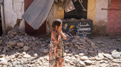 A child reacts after inspecting the damage caused by the earthquake, in her town of Amizmiz, near Marrakech, Morocco