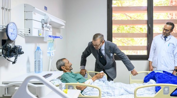 Morocco's King Mohammed VI, center, goes to the "Mohammed VI" University Hospital in Marrakech, Morocco.