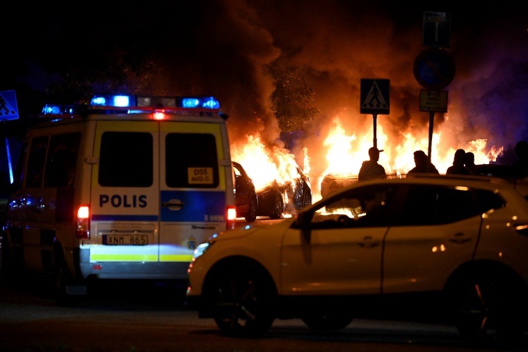 Cars burn during a riot in Malmo
