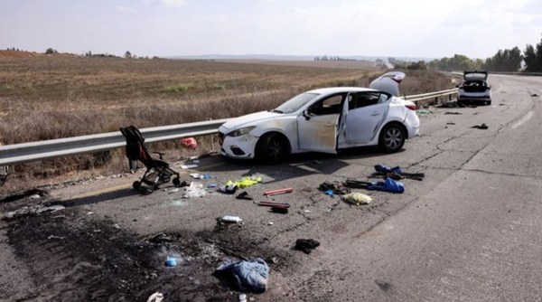Personal belongings, including a child's stroller, are found on the street near Kibbutz Kfar Azha in southern Israel, days after a mass invasion by Hamas militants from the Gaza Strip.