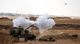An Israeli tank fires near Israel's border with the Gaza Strip, in southern Israel
