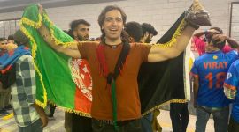 Afghanistan fan Haseebullah Siddiqi celebrates the team's win over England at the World Cup in Delhi metro.