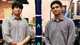 Agnikul cofounders Moin SPM and Srinath Ravichandran are pictured here next to a scale model of Agniban