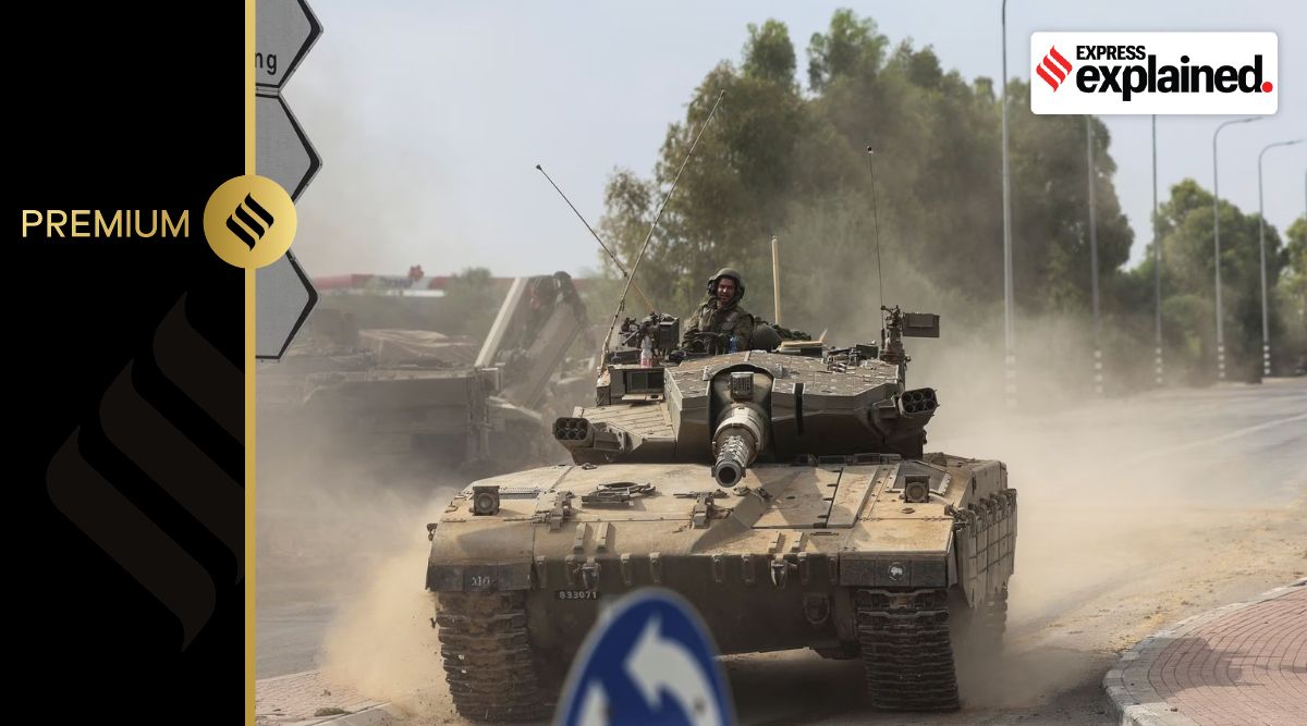 Israeli soldiers drive in a tank by Israel's border with Gaza in southern Israel, October 10, 2023. REUTERS