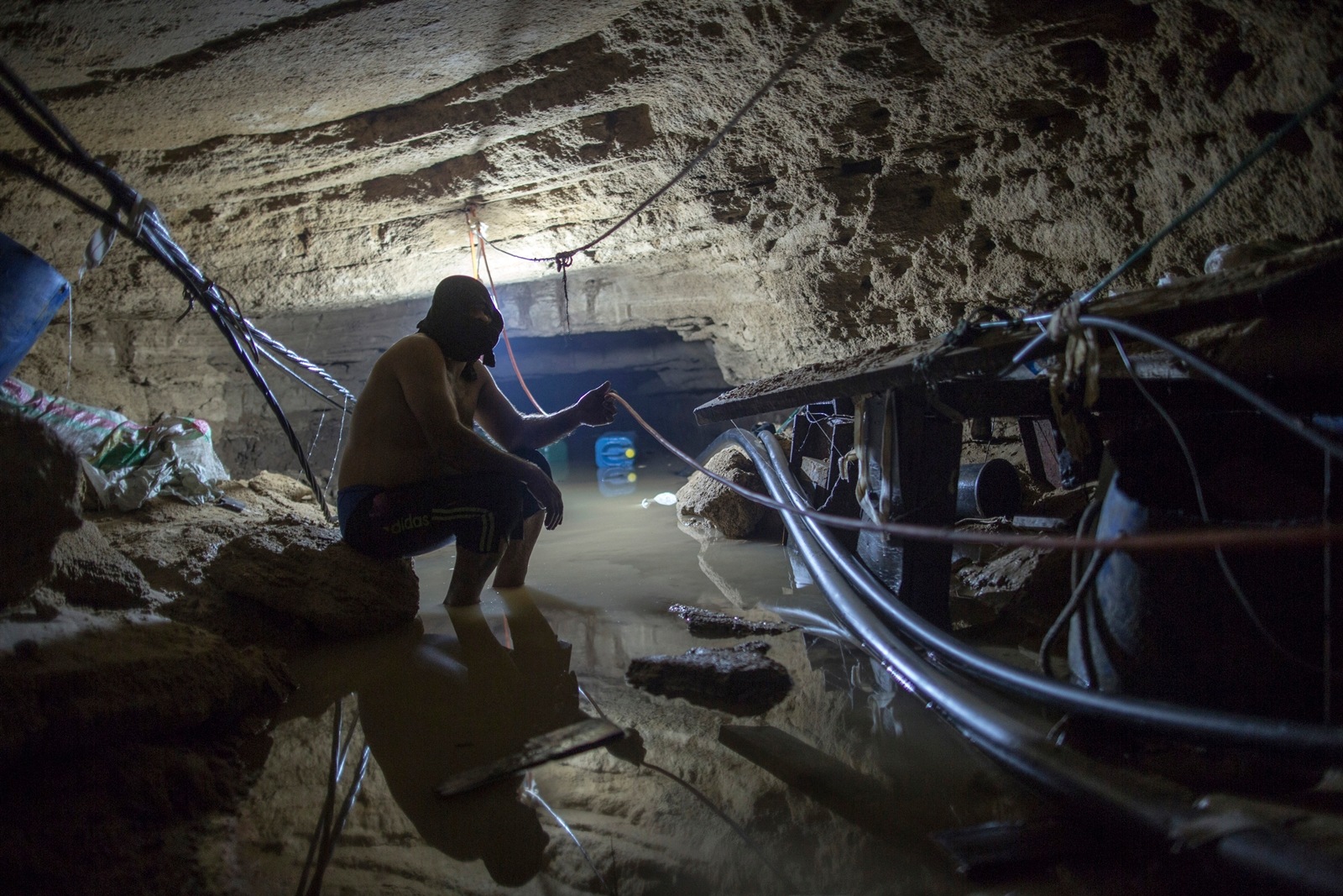 A Palestinian man in a flooded tunnel that was used to smuggle goods between Egypt and the Gaza Strip.